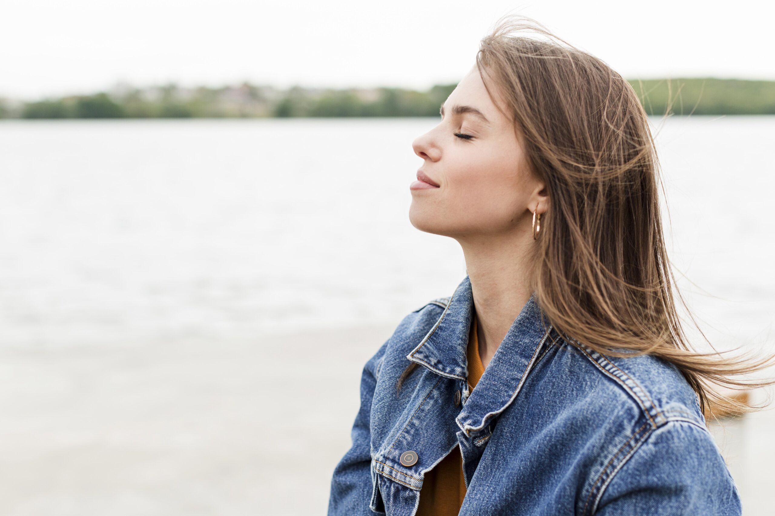 side-view-woman-enjoying-sea-breeze